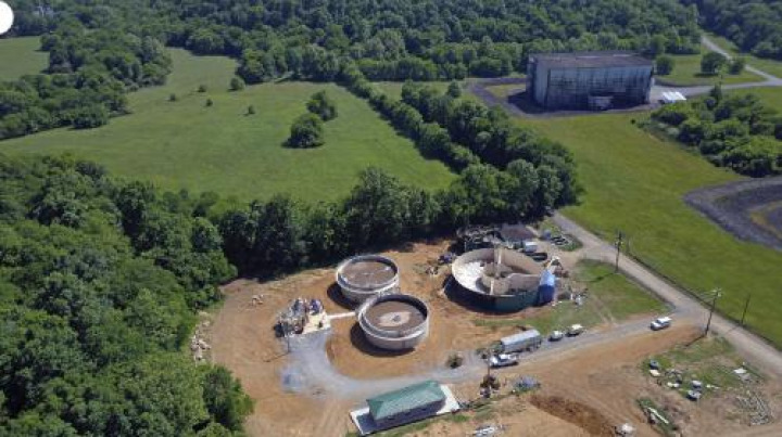 The SBR system includes the two concrete tanks on the left. The large metal tank (shown while under construction) includes the post-equalization basin and two digesters.
